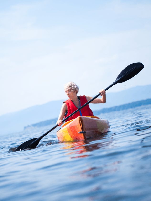 Woman kayaking on open water without glasses
